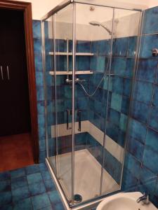 a glass shower in a bathroom with a sink at Appartamenti Vista Gransasso in LʼAquila