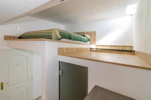 a room with wooden shelves and a green door at CASA ADA in Melenara