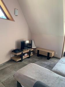 a living room with a tv and a table at Chez Pépé in Génos