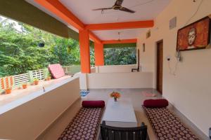 a room with a table and chairs and a window at Saptami Hampi Homestay in Hampi