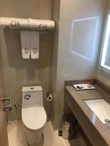 a bathroom with a toilet and a sink at Aram Hotel - AlMeshael Exit 18 in Riyadh