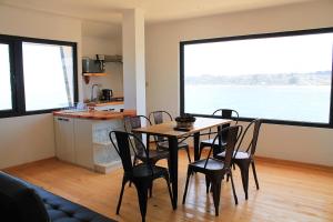 a kitchen and dining room with a table and chairs at Costanera240 in El Quisco +80 photos