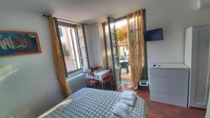 a bedroom with a bed and a desk and a window at B&B La Veranda - Iseo in Iseo