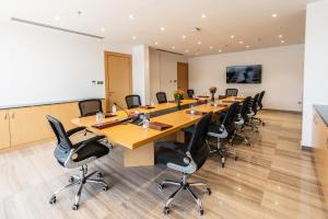 a large conference room with a long table and chairs at Aram Hotel - AlMeshael Exit 18 in Riyadh