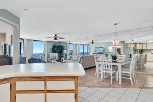 a living room and dining room with a kitchen and a dining table at Phoenix 5 Unit 612 in Orange Beach