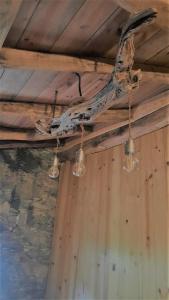 a tree branch hanging from a ceiling with lights at Casa de Cima in Lousã