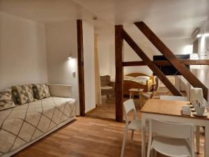 a living room with a couch and a table at Waldpension Harzer Waldwinkel in Bad Grund