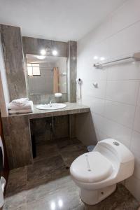 a bathroom with a toilet and a sink at El Portal De San Lázaro in Arequipa +50 photos