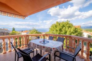 a balcony with a table and chairs with a view at Apartments Irini in Njivice