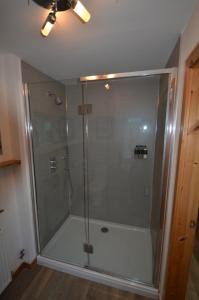 a shower with a glass door in a bathroom at The View at Pier House Glencoe in Glencoe