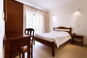 Postel nebo postele na pokoji v ubytování Ribeiro Hotel
