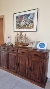 a wooden cabinet with a boat on top of it at Holidays Home Comporta in Comporta