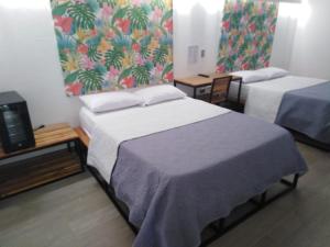 Postel nebo postele na pokoji v ubytování Hotel HACIENDA SAN AGUSTIN