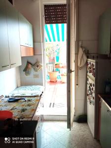 a kitchen with an open door to a patio at La Terrazza sul Mare in Levanto
