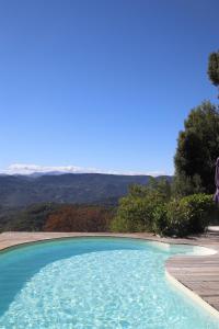 a swimming pool with a view of the mountains at La Vela in Peille