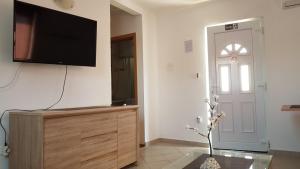 a living room with a flat screen tv on a wall at Apartment Zorica in Vodice