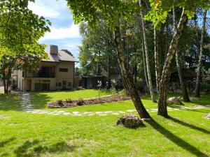 a house with a tree in the yard at PRZYTULIA in Olsztyn