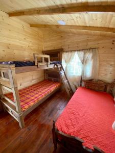 een slaapkamer met 2 stapelbedden in een blokhut bij Cabaña el kiosko in Zipaquirá