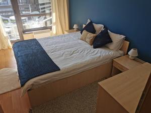 a bed with pillows on it in a bedroom at Na planina in Razlog