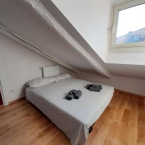 a white bed in a room with a window at Casa Breton in Turin