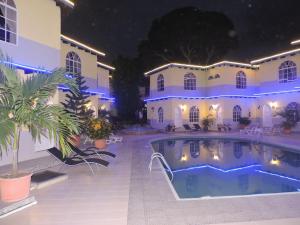a large house with a swimming pool at night at Hotel Puerto Gaviota in Tonsupa