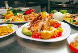 a table with plates of food on a table at Hotel Puerto Gaviota in Tonsupa