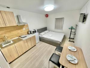 a small room with a kitchen and a small apartment at Apartments Osokorky House in Kyiv