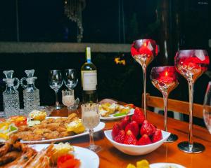 a table topped with plates of food and wine glasses at Hotel Puerto Gaviota in Tonsupa