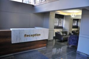 a reception desk in a lobby with chairs and a reception counter at SAKA LİFE OTEL in Erzurum