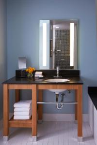a bathroom with a sink and a mirror at Kimpton Shorebreak Huntington Beach Resort, an IHG Hotel in Huntington Beach