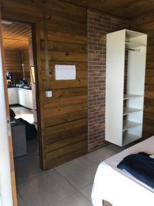 um quarto com uma porta de madeira e uma cozinha em Casa de Madeira em Delfinópolis