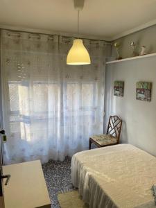 A bed or beds in a room at APARTAMENTO TURISTICO MILLAN