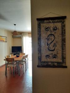 a dining room with a table and a painting on the wall at Aires Andinos in Mendoza