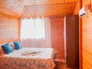 a bedroom with a bed in a wooden room at Casa família bonfim in Urubici