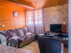 a living room with a couch and a flat screen tv at Casa família bonfim in Urubici