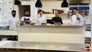 a group of chefs standing behind a counter in a kitchen at Ngati Ruanui Stratford Mountain House in Stratford