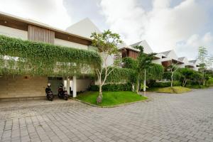 a building with two motorcycles parked in front of it at Aurelia Residence in Uluwatu
