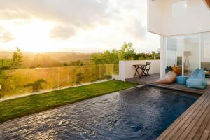 a swimming pool on the roof of a house at Aurelia Residence in Uluwatu