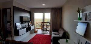 a living room with a couch and a window at Apartamento em Bananeiras in Bananeiras