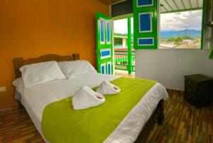 a bedroom with a bed with towels on it at Hotel La Floresta Salento in Salento