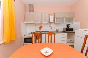 a small kitchen with a table and two chairs at Apartment Town View in Korčula