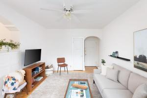 a white living room with a couch and a tv at Flexhome Economy 2BR Apartment B2 - READ INFO in Milwaukee