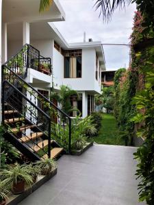 a house with a staircase in front of it at Alojamiento Familiar Custodia in Tarapoto