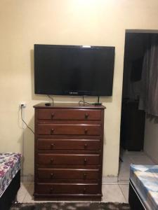 a flat screen tv on top of a dresser at !!Casa na Penha toda Mobiliada em rua Tranquila! in Rio de Janeiro