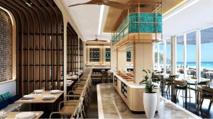a restaurant with tables and chairs and a view of the ocean at Swiss-Belcourt Kupang in Kupang