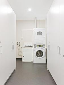a laundry room with a washing machine and a washer at Padstow Park Hotel in Padstow