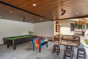 a patio with a pool table and some chairs at Villa Calangute Phase 3 in Calangute