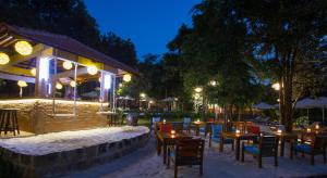 a restaurant with tables and chairs in the snow at night at Valley Village Resort Phu Quoc in Phú Quốc