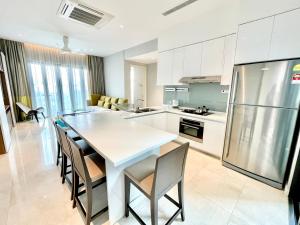 a kitchen with a table and chairs and a refrigerator at KLCC Luxury Condo Damai 88 Near Gleneagles Hospital in Kuala Lumpur