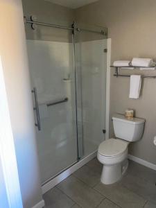 a bathroom with a toilet and a glass shower at North Bay Inn Santa Rosa in Santa Rosa +8 photos